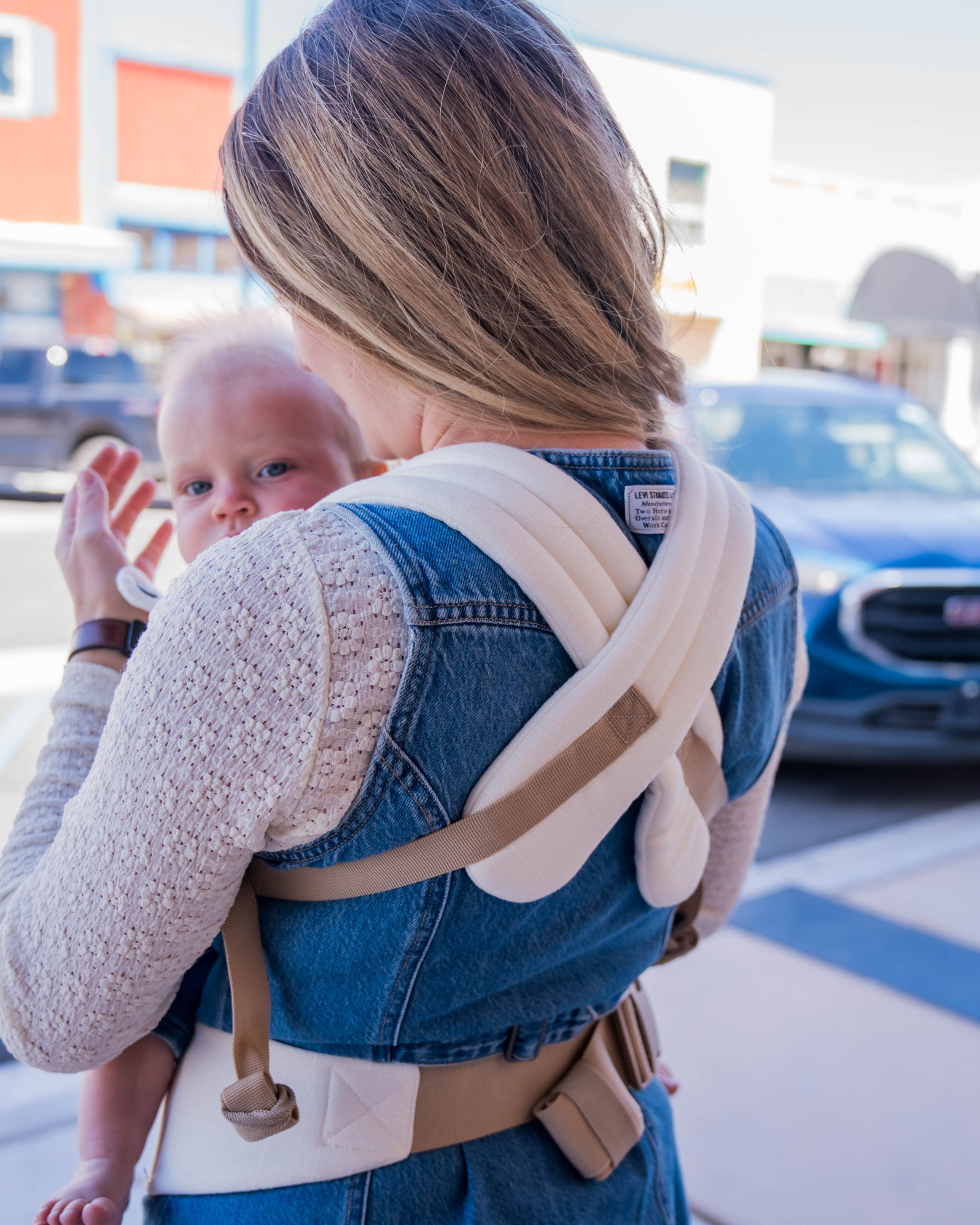 cream ergonomic baby carrier back view