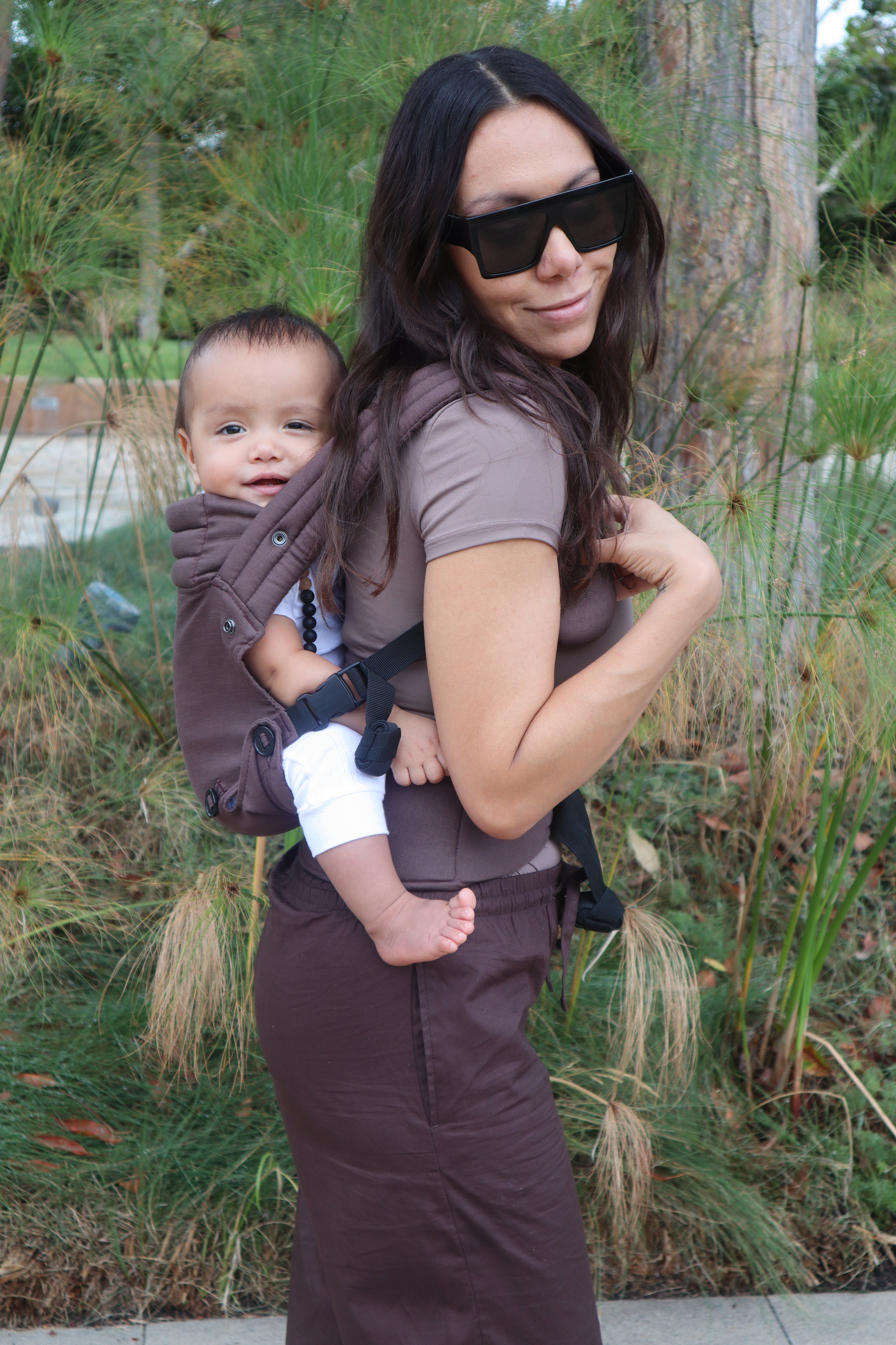 Brown baby carrier with back carry position